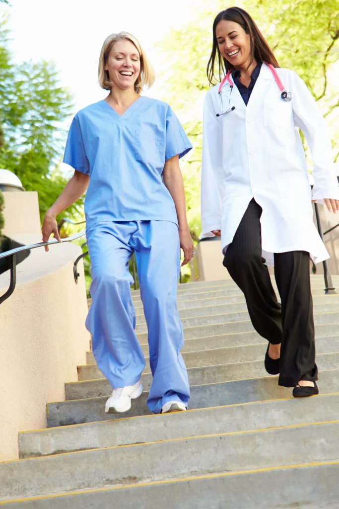 Two healthcare workers walking outdoors, illustrating personal security for hospital staff