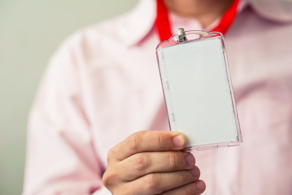 Employee holding a proximity card used for building access control