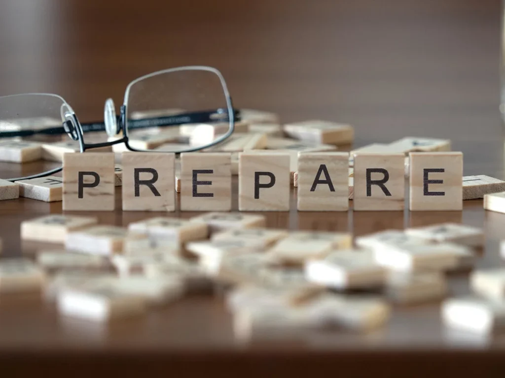 Letter tiles spelling PREPARE, representing emergency preparedness planning for businesses