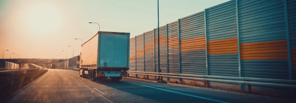 Semi truck on a highway at sunset, from the SAP Insights article quoting SRMC CEO Lynda L. Buel
