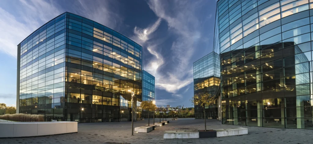 Glass office buildings at dusk, representing integrated security technology design