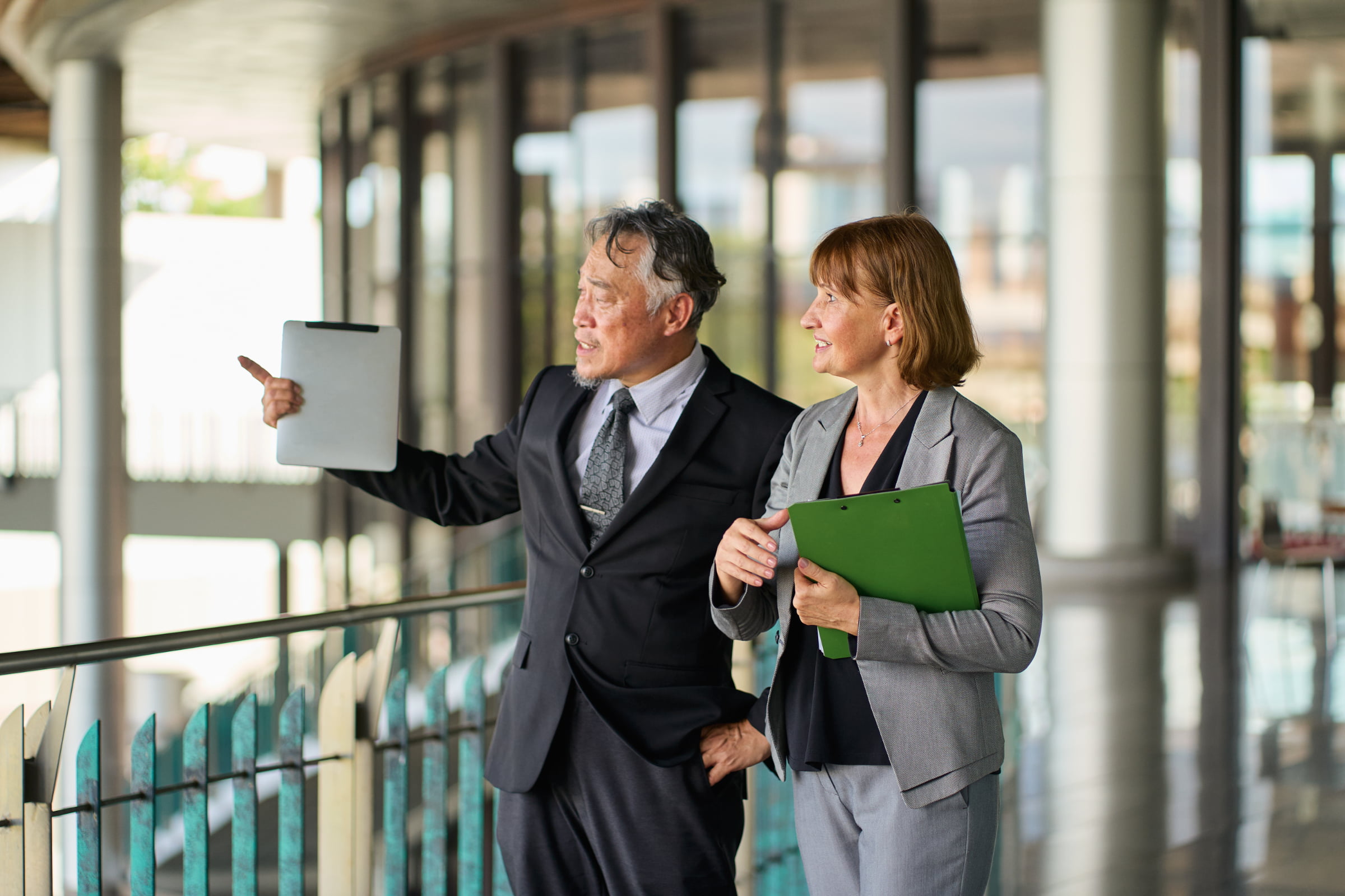 Two professionals walking through a building during a physical security assessment